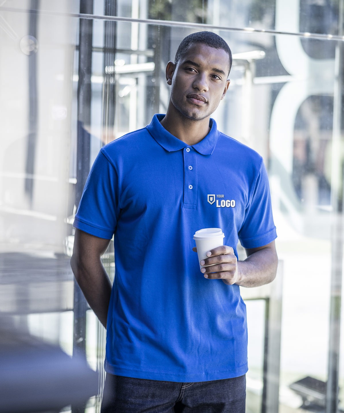 Man in a royal blue polo shirt with a logo embroidered on the left chest